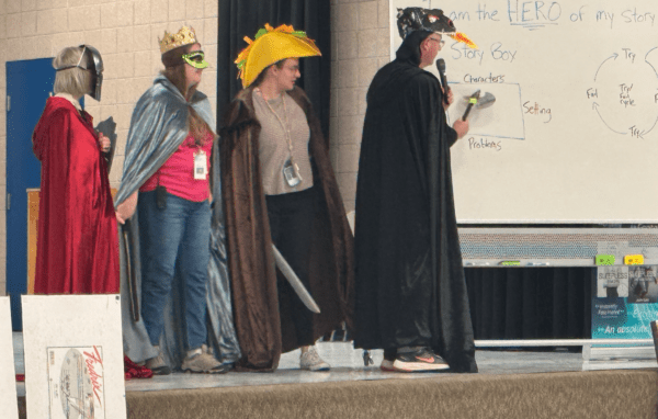 5th grade teachers and author Johan Twiss dressed up on stage